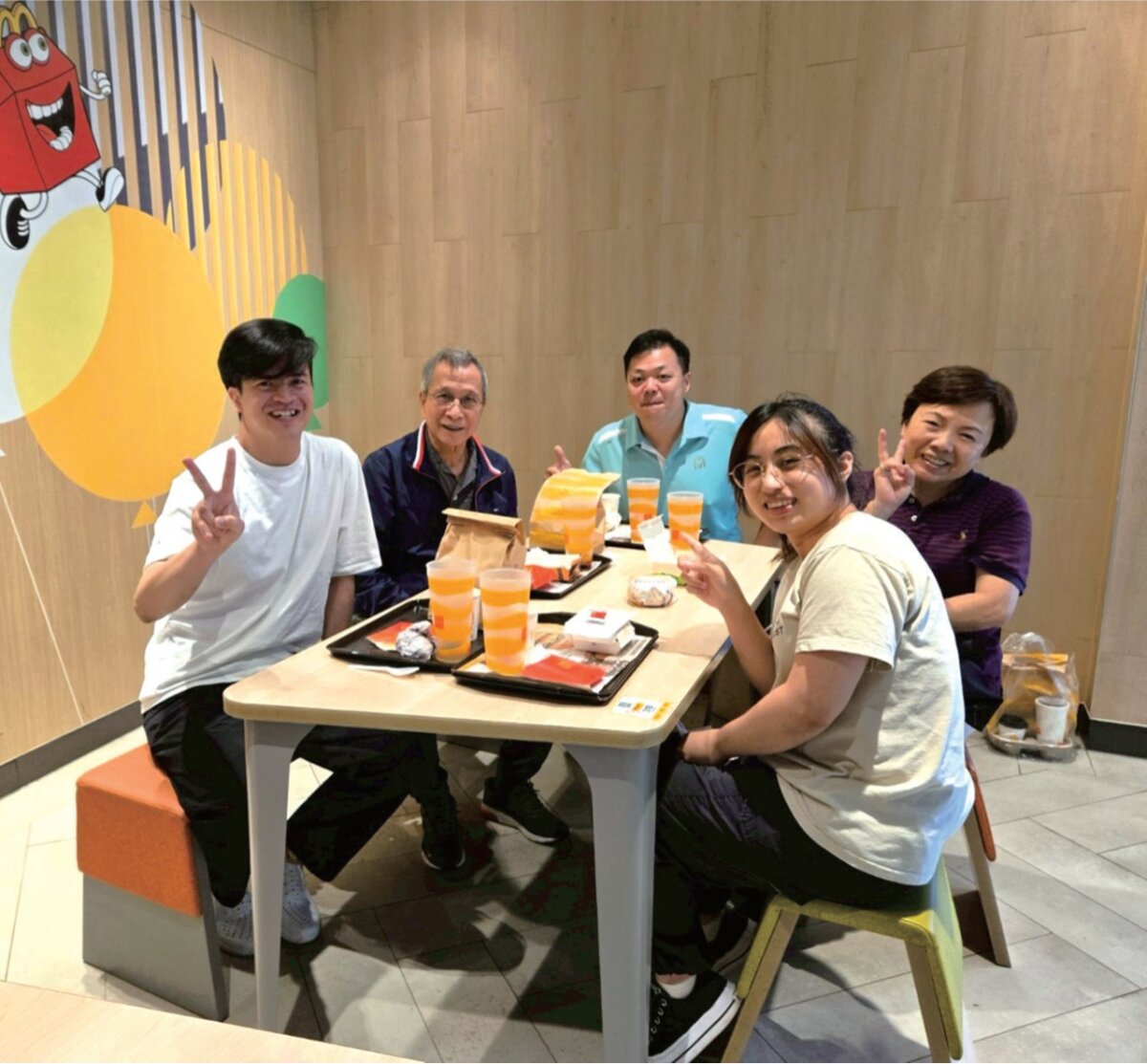 照顧團隊幫郭伯伯圓夢，訓練多時終於吃到麥當勞漢堡套餐。(圖片來源/ 雙連安養中心)