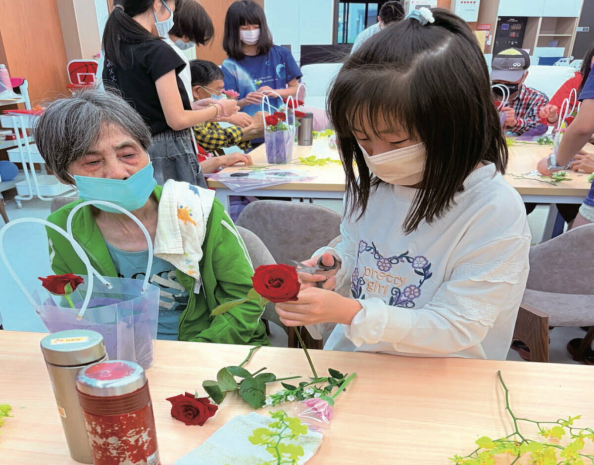 青銀共學，木柵國小學童走進日照與阿公阿嬤一起學習插花。(圖片來源/圓石社區長照機構)